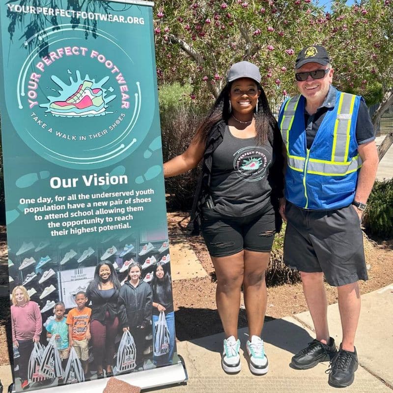 Rotary Club of Green Valley volunteer standing with organizer at Your Perfect Footwear event providing shoes for underserved youth